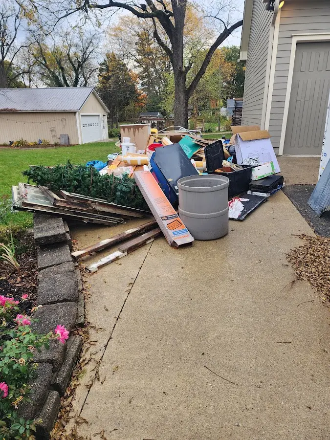 Dumpster being loaded with debris for Estate Cleanout Dumpster Rental in Pembroke Pines
